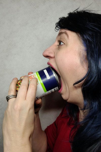 Woman puts can inside mouth
